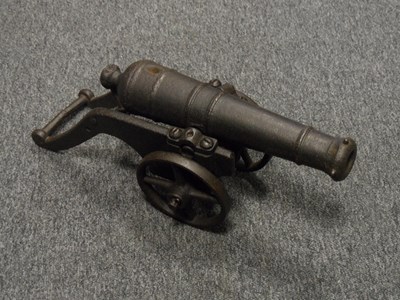 Lot 376 - A MINIATURE IRON CANNON