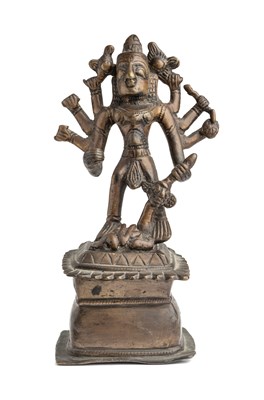 Lot 584 - A FOLK BRONZE FIGURE OF DURGA SLAYING THE BUFFALO DEMON, WESTERN DECCAN, INDIA, 18TH / 19TH CENTURY