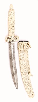 Lot 159 - A FINELY CARVED IVORY-MOUNTED DAGGER