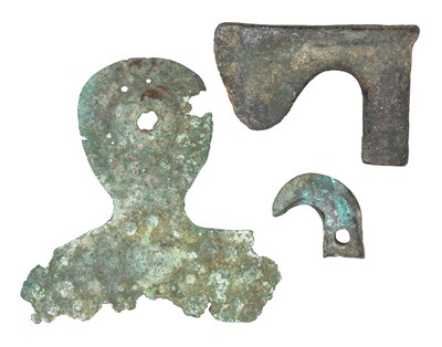 Lot 58 - â€¡ A NORTH-WEST PERSIAN BRONZE AXE-HEAD AND TWO FURTHER BRONZE ELEMENTS