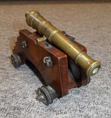 Lot 326 - A MINIATURE BRONZE CANNON
