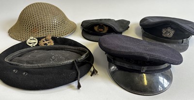 Lot 410 - A BRITISH WW2 STEEL HELMET AND AN ASSORTMENT OF PEAKED CAPS