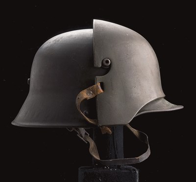 Lot 133 - A RARE GERMAN MODEL 1916 STEEL HELMET COMPLETE WITH ITS BROW DEFENCE