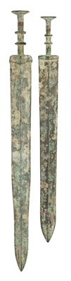 Lot 131 - TWO CHINESE BRONZE SWORDS (JIAN), PROBABLY ZHOU DYNASTY OR EARLY WARRING STATES (1050-221 BC) AND TWO FURTHER SWORDS IN ZHOU DYNASTY STYLE