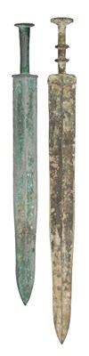 Lot 132 - TWO CHINESE BRONZE SWORDS (JIAN), PROBABLY ZHOU DYNASTY OR EARLY WARRING STATES (1050-221 BC) AND THREE FURTHER SWORDS IN ZHOU DYNASTY STYLE