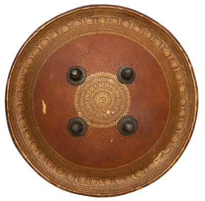 Lot 78 - **AN INDO-PERSIAN HIDE SHIELD (DHAL)