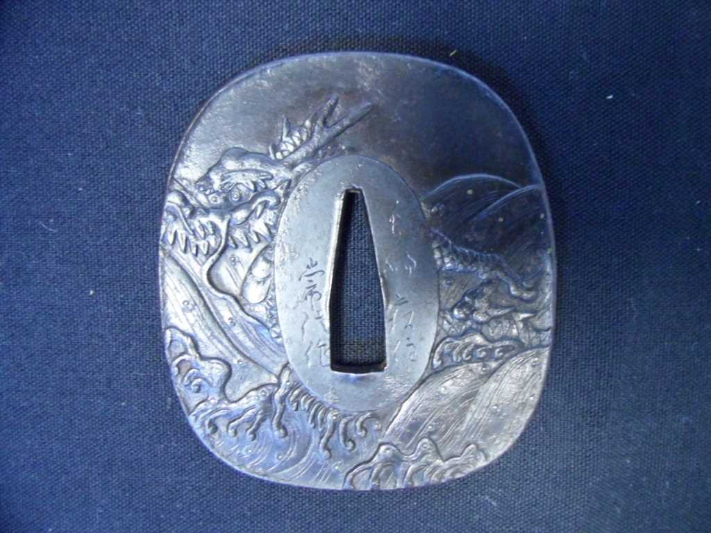 Lot 51 - A JAPANESE SWORD GUARD (TSUBA)