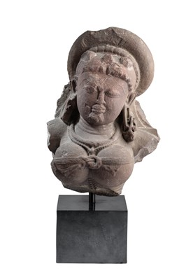 Lot 552 - A PINK SANDSTONE FRAGMENTARY BUST OF DURGA, CENTRAL INDIA, CIRCA 10TH CENTURY