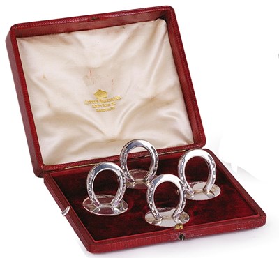 Lot 250 - A SET OF FOUR SILVER 'HORSESHOE' CARD HOLDERS