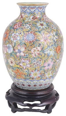 Lot 11 - A SMALL CHINESE FAMILLE ROSE MILLEFLEUR EGGSHELL VASE