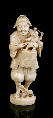 Lot 78 - A JAPANESE IVORY OKIMONO OF A PUPPETEER, MEIJI