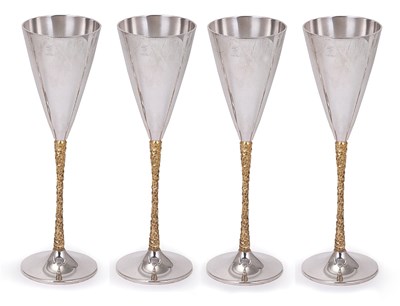 Lot 146 - A SET OF FOUR PARCEL-GILT-SILVER GOBLETS