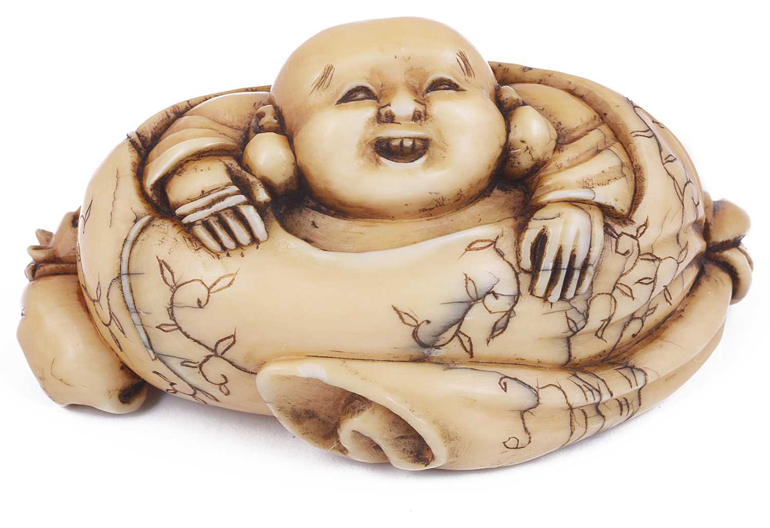 Lot 118 - ~STAINED IVORY NETSUKE OF HOTEI IN HIS SACK