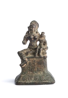 Lot 569 - A SMALL CHOLA BRONZE FIGURE OF YASHODA WITH THE INFANT KRISHNA, TAMIL NADU,, CIRCA 12TH CENTURY