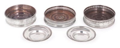 Lot 264 - THREE ASSORTED GEORGE III SILVER WINE COASTERS