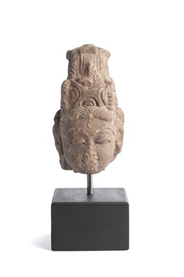 Lot 553 - A BUFF SANDSTONE HEAD OF A DEITY, CENTRAL INDIA, 10TH/11TH CENTURY