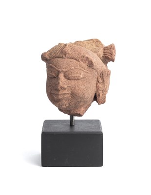 Lot 556 - A PINKISH BUFF SANDSTONE HEAD OF A FEMALE DEITY, MADHYA PRADESH, CENTRAL INDIA, 11TH/12TH CENTURY