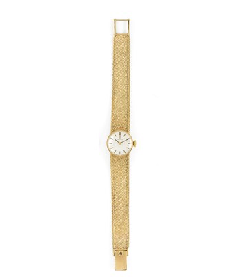 Lot 546 - OMEGA: A LADY'S GOLD BRACELET WATCH