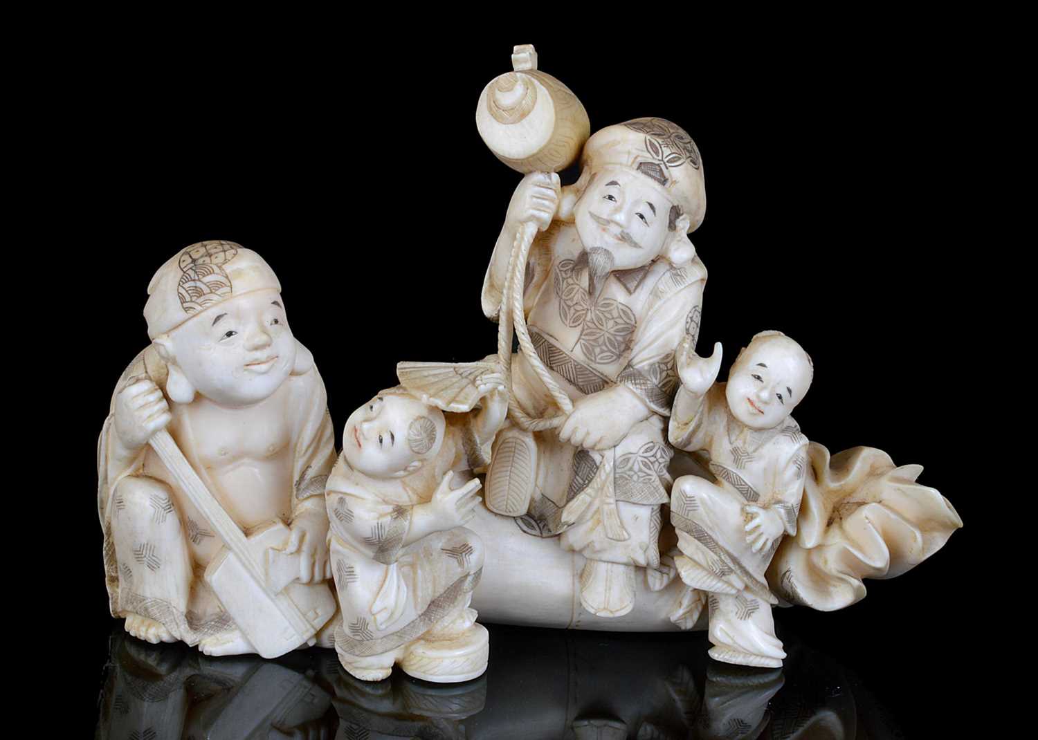 Lot 174 - A JAPANESE IVORY OKIMONO OF HOTEI AND DAIKOKU