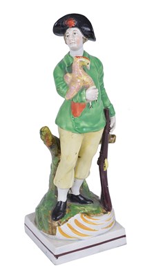 Lot 40 - A STAFFORDSHIRE PEARLWARE FIGURE OF A GAMEKEEPER