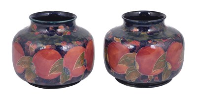 Lot 47 - POMEGRANATE: A NEAR PAIR OF MOORCROFT SQUAT VASES