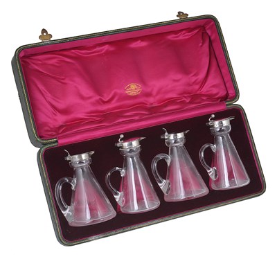 Lot 214 - A MATCHED SET OF FOUR SILVER-MOUNTED GLASS WHISKY TOTS