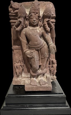 Lot 201 - A PINK SANDSTONE RELIEF PANEL DEPICTING SURYA, CENTRAL INDIA, 11TH/12TH CENTURY