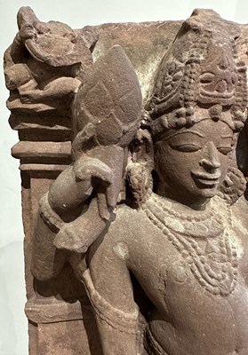 Lot 201 - A PINK SANDSTONE RELIEF PANEL DEPICTING SURYA, CENTRAL INDIA, 11TH/12TH CENTURY