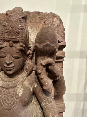 Lot 201 - A PINK SANDSTONE RELIEF PANEL DEPICTING SURYA, CENTRAL INDIA, 11TH/12TH CENTURY