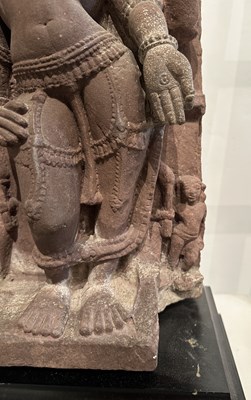 Lot 201 - A PINK SANDSTONE RELIEF PANEL DEPICTING SURYA, CENTRAL INDIA, 11TH/12TH CENTURY