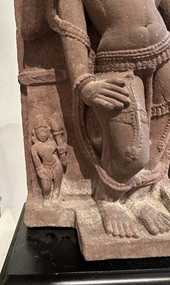 Lot 201 - A PINK SANDSTONE RELIEF PANEL DEPICTING SURYA, CENTRAL INDIA, 11TH/12TH CENTURY