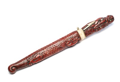 Lot 121 - A JAPANESE RED LACQUER AND BONE MOUNTED TANTO DAGGER, MEIJI PERIOD (1868-1912)