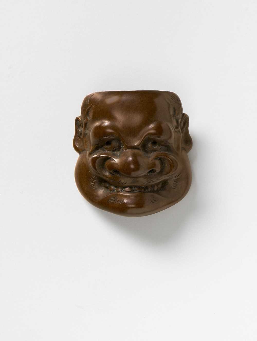 Lot 115 - A JAPANESE MASK NETSUKE OF BUAKU