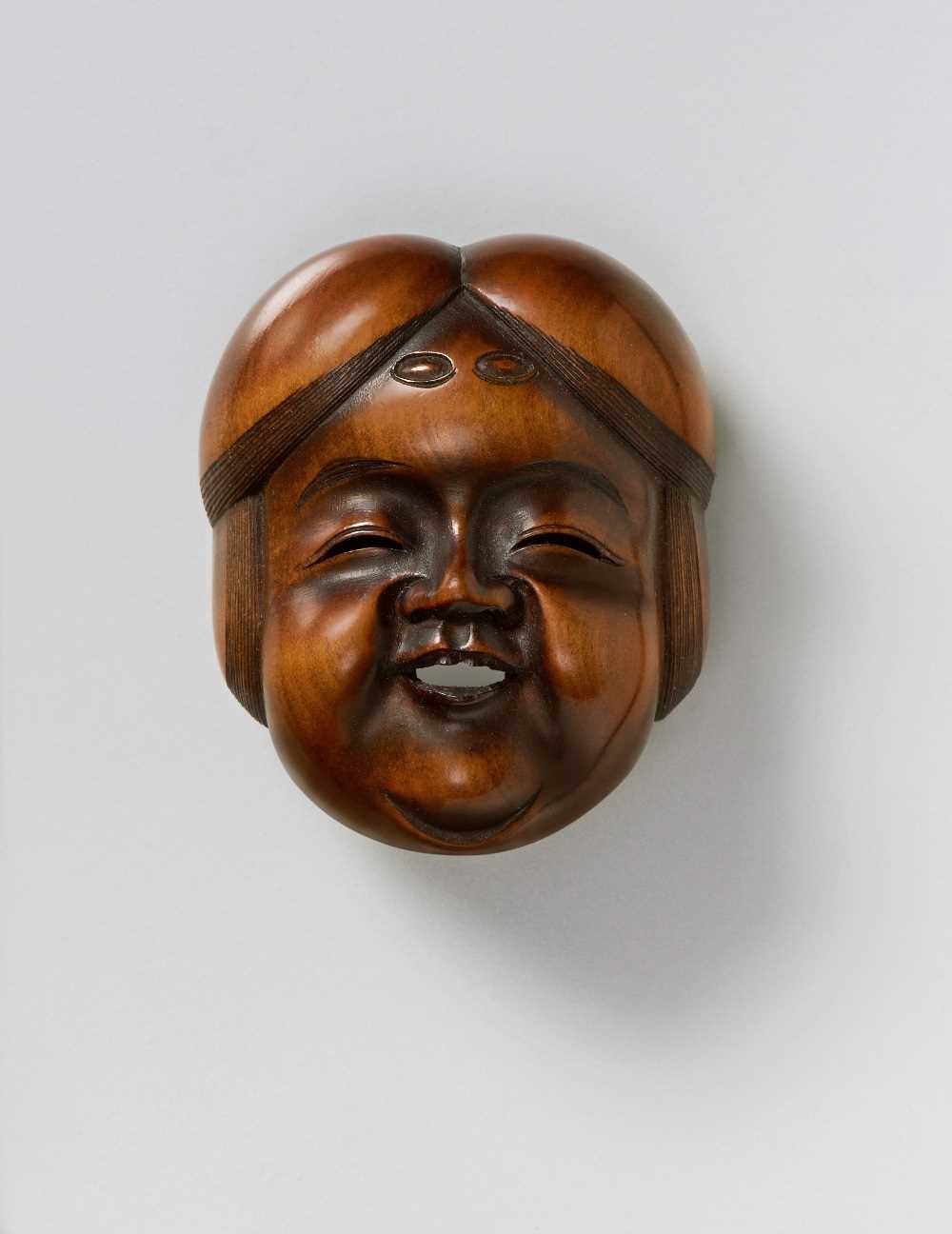 Lot 137 - A JAPANESE MASK NETSUKE OF OKAME