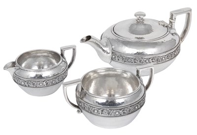 Lot 163 - A GEORGE V ARTS AND CRAFTS SILVER THREE-PIECE TEA SET