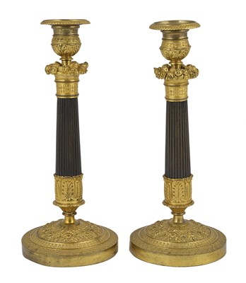 Lot 53 - A PAIR OF RESTAURATION GILT AND PATINATED BRONZE CANDLESTICKS