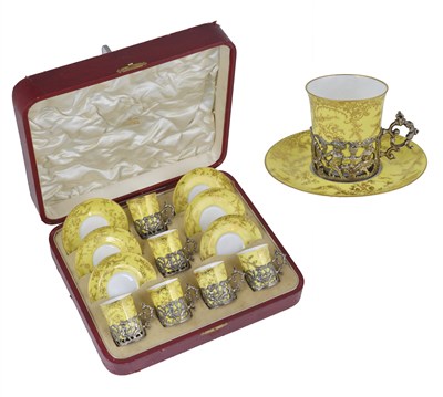 Lot 197 - A SET OF SIX EDWARDIAN SILVER HOLDERS WITH DEMI-TASSE CUPS AND SAUCERS