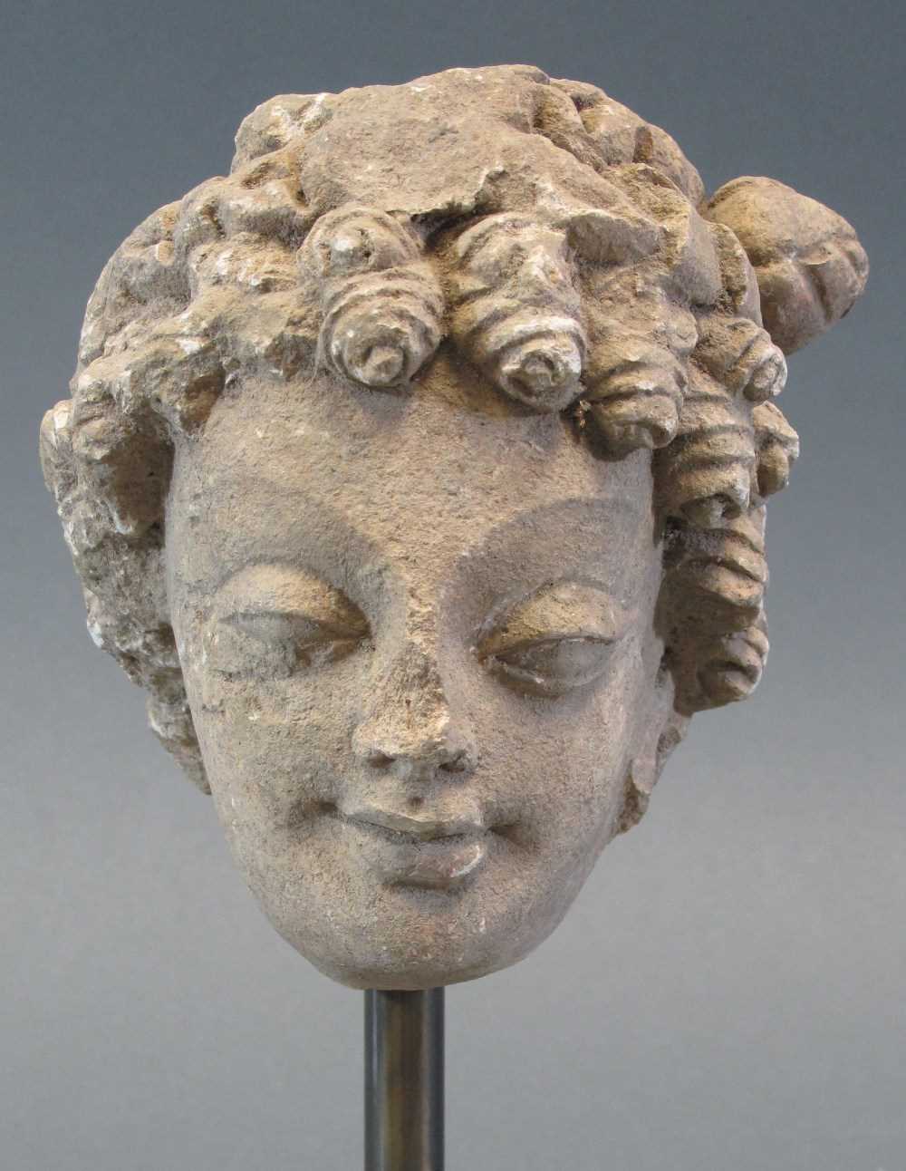 Lot 118 - A GANDHARA STUCCO HEAD OF A BODHISATTVA