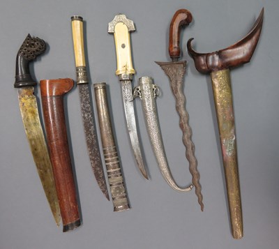 Lot 24 - ËœA BURMESE DHA DAGGER, A MALAYSIAN DAGGER, A MALAYSIAN DAGGER, A NORTH AFRICAN DAGGER