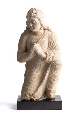 Lot 60 - A GANDHARA STUCCO RELIEF FIGURE OF A DEVOTEE