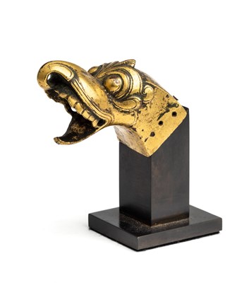 Lot 103 - A COPPER GILT FINIAL IN THE FORM OF MAKARA HEAD