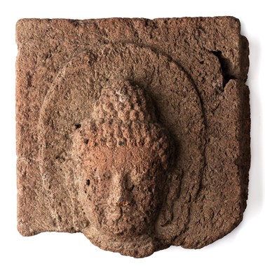 Lot 223 - A VOLCANIC STONE PANEL DEPICTING THE HEAD OF BUDDHA