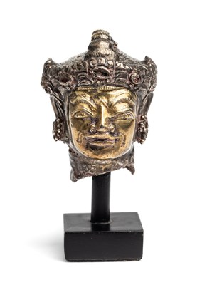 Lot 304 - A PARCEL GILT SHEET SILVER HEAD OF A DEITY