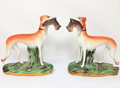 Lot 513 - A PAIR OF STAFFORDSHIRE FIGURES OF GREYHOUNDS