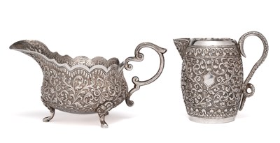 Lot 110 - AN KUTCH-STYLE SILVER MILK JUG AND SAUCEBOAT