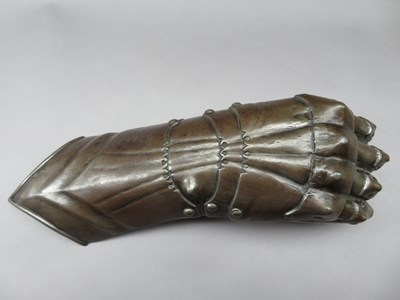 Lot 300 - A CAST IRON FINGERED GAUNTLET FROM AN ARMOUR IN GERMAN HIGH GOTHIC STYLE