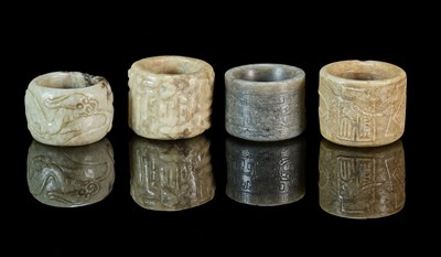 Lot 85 - A GROUP OF FOUR CHINESE CARVED JADE ARCHERS RINGS, QING DYNASTY, 19TH CENTURY