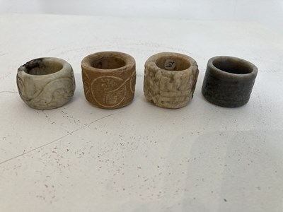 Lot 85 - A GROUP OF FOUR CHINESE CARVED JADE ARCHERS RINGS, QING DYNASTY, 19TH CENTURY