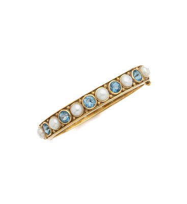 Lot 357 - CULTURED PEARL AND BLUE TOPAZ BANGLE