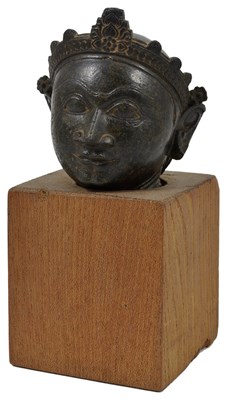 Lot 144 - A BLACK STONE HEAD OF KRISHNA